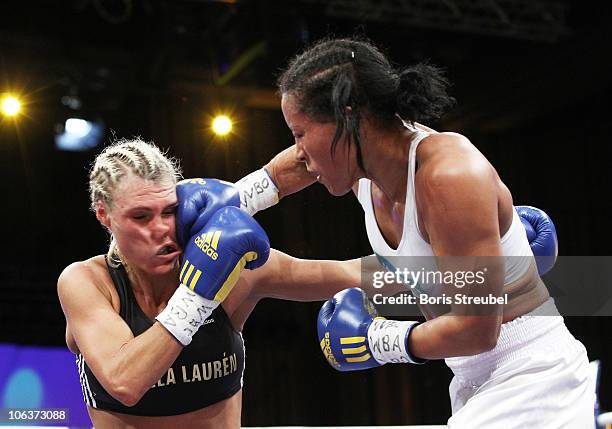 Mikaela Lauren of Schweden and Cecilia Braekhus of Norway exchange punches during their WBC WBA WBO Female Welterweight title fight at Stadthalle...