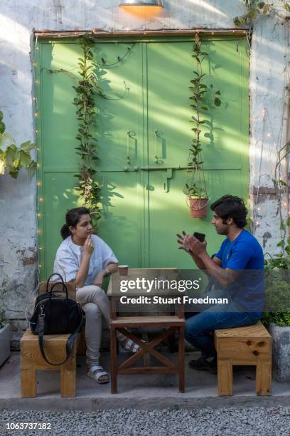 Couple working at the JugMugThela shop in Champa Gali, New Delhi, India. Champa Gali is the latest and most intimate of Delhi's urban creative...