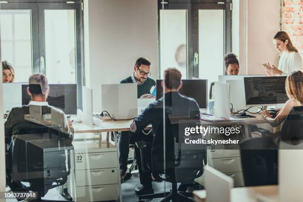large group of programmers working on desktop pcs in the office. - large group of people office stock pictures, royalty-free photos & images