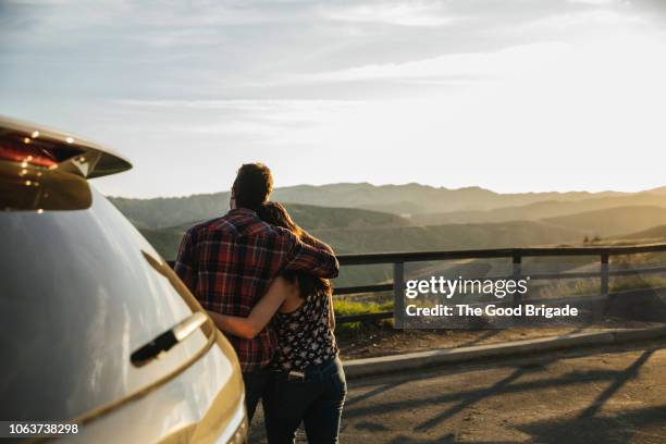 couple enjoying view of mountains on road trip - california road trip stock pictures, royalty-free photos & images