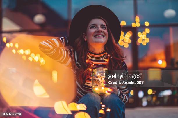 cheerful woman with christmas lights - illuminated stock pictures, royalty-free photos & images
