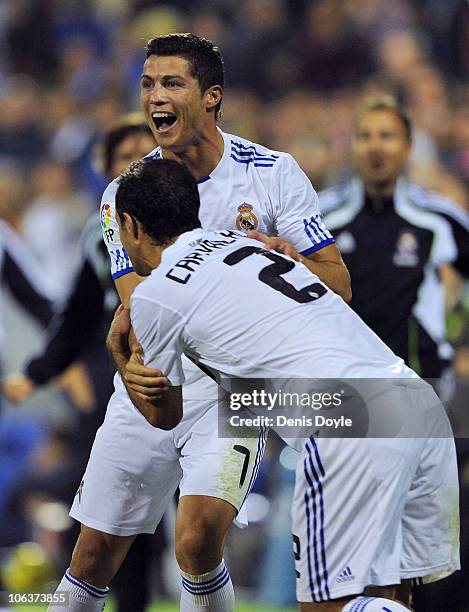 Cristiano Ronaldo of Real Madrid celebrates with Ricardo Carvalho after scoring his team's second goal during the La Liga match between Hercules FC...