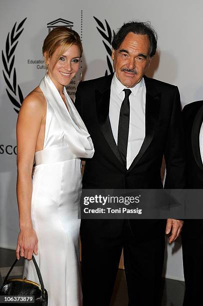 Oliver Stone and Florine Elena Deplazes attends the UNESCO Charity-Gala 2010 at Maritim Hotel on October 30, 2010 in Duesseldorf, Germany.