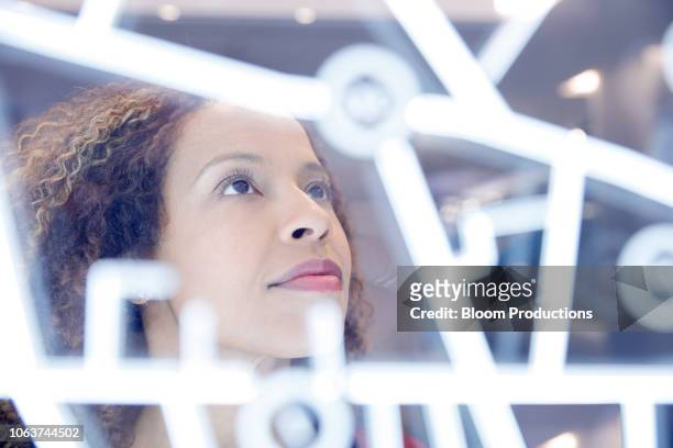 portrait of woman operating digital interface technology - innovation foto e immagini stock