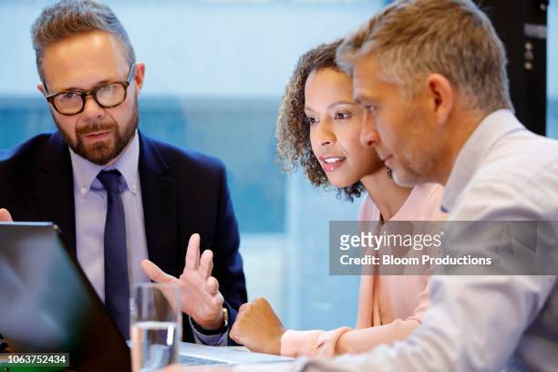 financial advisor having a meeting with couple - pension saving stock pictures, royalty-free photos & images