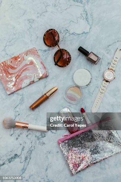 top view of set female accessories on marble  pink flat lay - beauty case stockfoto's en -beelden