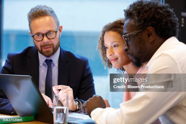 financial advisor having a meeting with clients - schuldenberatung stock-fotos und bilder