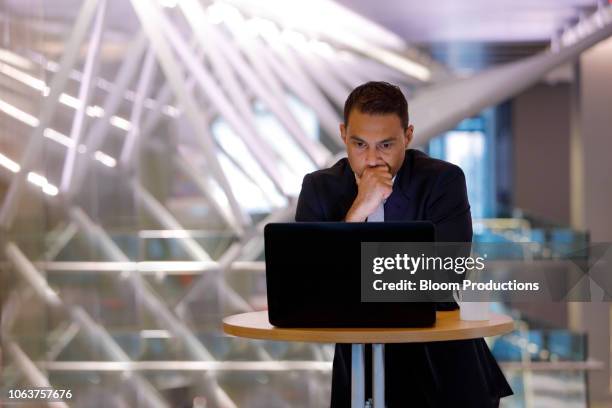 serious businessman looking at a laptop - worry business stock pictures, royalty-free photos & images