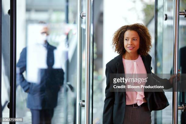 businesswoman on the move - walking into door stock-fotos und bilder