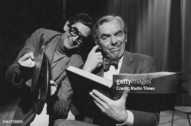 Comedy partners Denis Norden and Frank Muir pictured performing a sketch, December 1973.