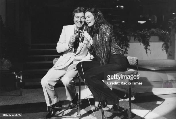 Comedian and television personality Des O'Connor and actress Lynda Carter pictured performing together, September 21st 1980.