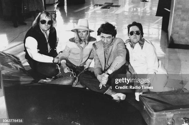 Portrait of the cast of comedy show 'Not the Nine O'Clock News'; Mel Smith, Pamela Stephenson, Rowan Atkinson and Griff Rhys Jones, sitting on the...