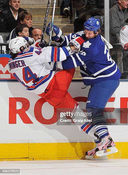 Colton Orr of the Toronto Maple Leafs checks Steve Eminger of the New York Rangers during game action October 30, 2010 at the Air Canada Centre in...