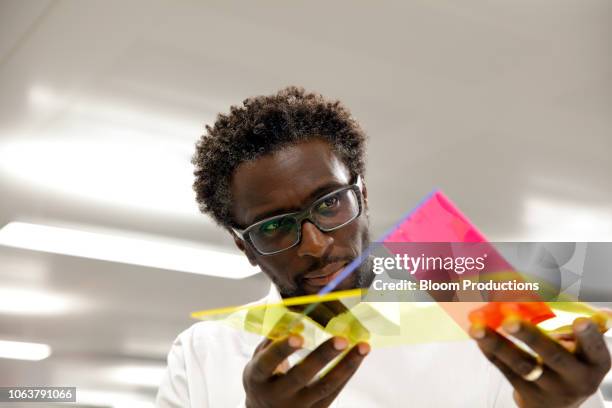 designer examining a prototype - designers working bildbanksfoton och bilder