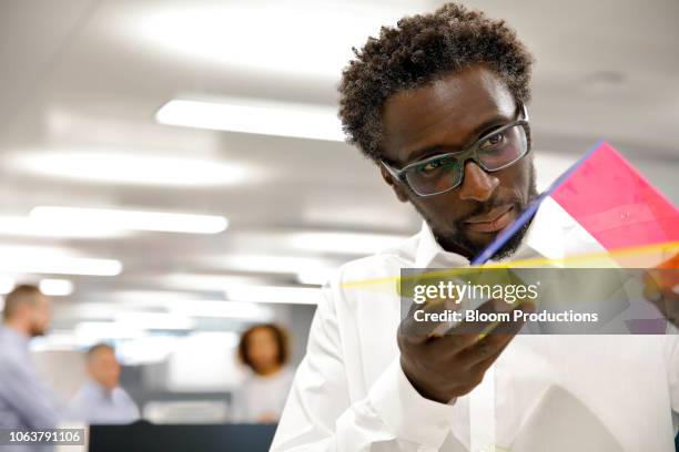 designer examining a prototype - プロトタイプ ストックフォトと画像