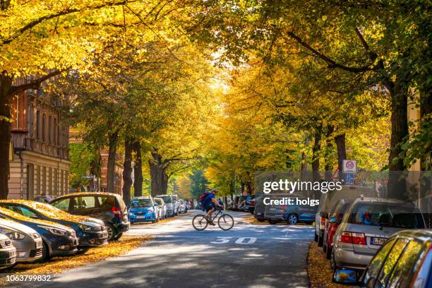 parked cars in leipzig street, germany - leipzig saxony stock pictures, royalty-free photos & images