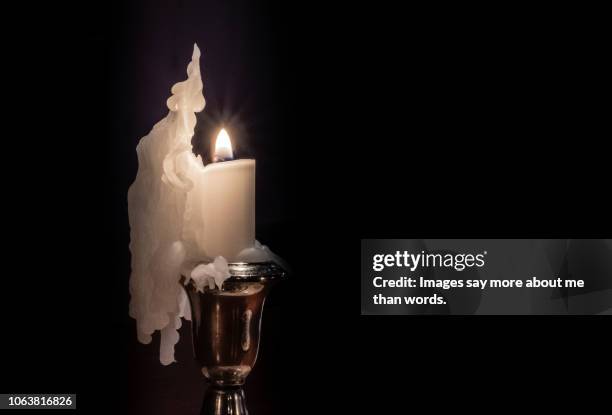 a silver candlestick with a melting candle forming a beautiful sculpture. still life. - images of brazilian wax fotografías e imágenes de stock