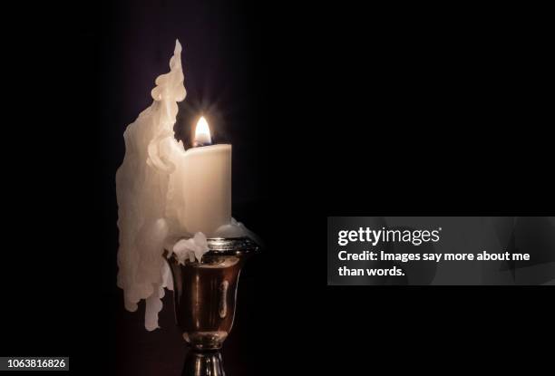 a silver candlestick with a melting candle forming a beautiful sculpture. still life. - images of brazilian wax 個照片及圖片檔