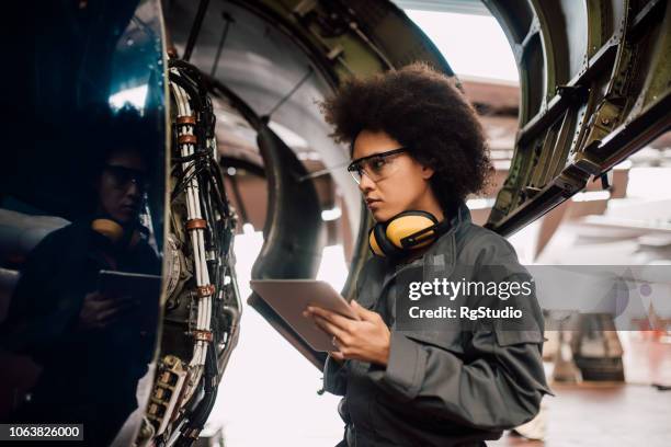 young mechanic using digital tablet - aircraft engineer stock pictures, royalty-free photos & images