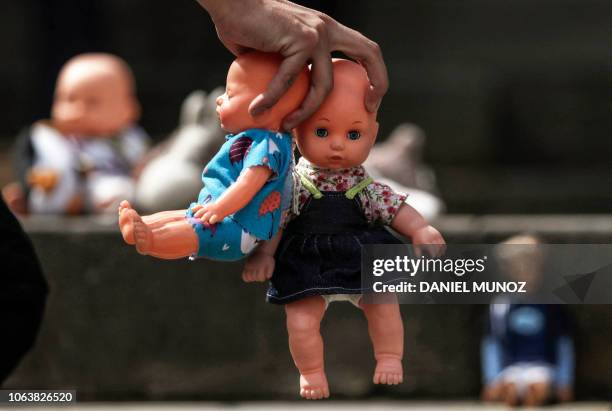 Toys are placed on the steps of the Colombian Congress building to protest against sexual violence against children, in Bogota on November 20, 2018....