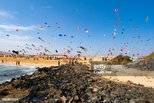 kites flying at the international kite festival in fuerteventura - corralejo stock pictures, royalty-free photos & images