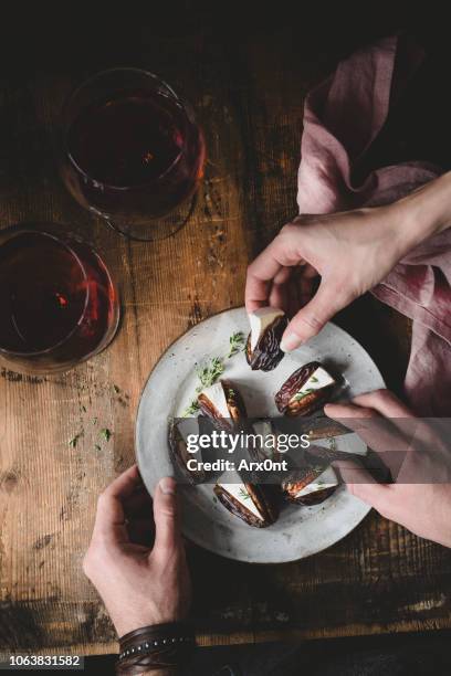 people taking snacks from plate - foodie stockfoto's en -beelden