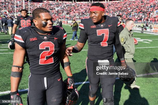 Dobbins of the Ohio State Buckeyes and Dwayne Haskins of the Ohio State Buckeyes walk off the field after a victory over the Nebraska Cornhuskers at...