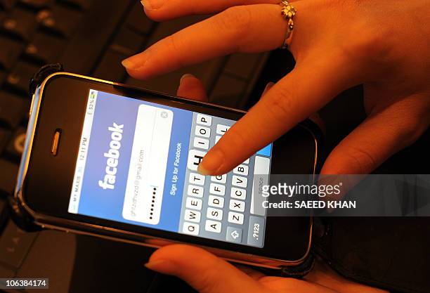 Malaysian professional writes her password to enter facebook for social networking in Kuala Lumpur on October 31, 2010. Malaysians are the most...