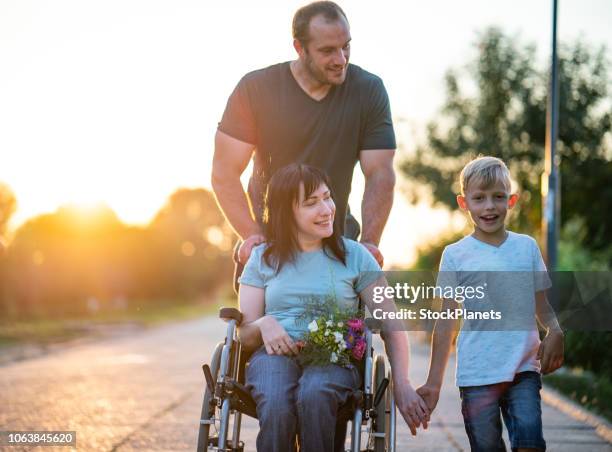 portrait happy family with disability mother - paraplégico imagens e fotografias de stock