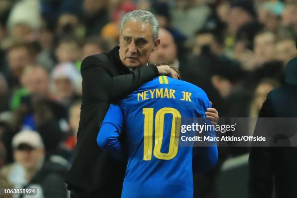 Neymar of Brazil is embraced by Tite manager of Brazil as he goes off injured early in the game during the International Friendly match between...