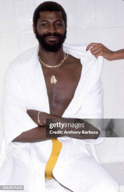 Portrait of American Soul, R&B, and Funk musician Teddy Pendergrass , dressed in a white bathrobe and yellow shorts, as he sits, arms folded in a...