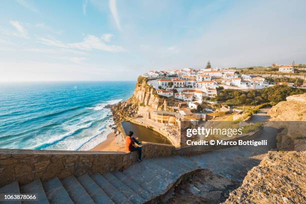 tourist admiring the view in azenhas do mar, lisbon - azenhas do mar stock-fotos und bilder