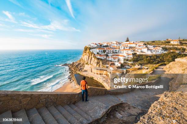 tourist admiring the view in azenhas do mar, lisbon - european landscape stockfoto's en -beelden