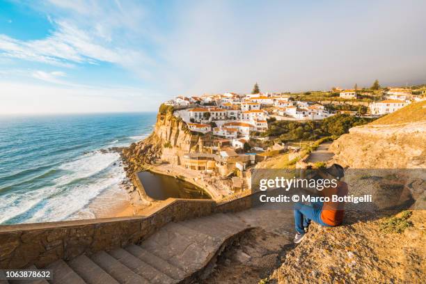 tourist taking pictures with smartphone at azenhas do mar, lisbon - azenhas do mar stock-fotos und bilder