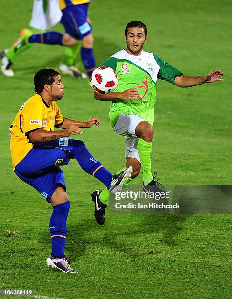 Bradley McDonald of the Fury contests the ball with Tahj Minniecon of the Gold Coast during the round 12 A-League match between the North Queensland...