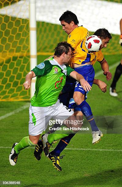 Mark Hughes of the Fury contests the ball with Steven Fitzsimmons of the Gold Coast during the round 12 A-League match between the North Queensland...