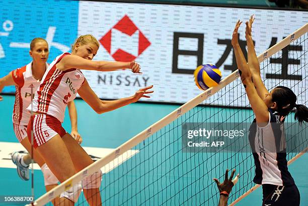 Poland's Berenika Okuniewska spikes the ball to Paola Ramirez Vargas of Costa Rica during the first round of the world woman's volleyball...