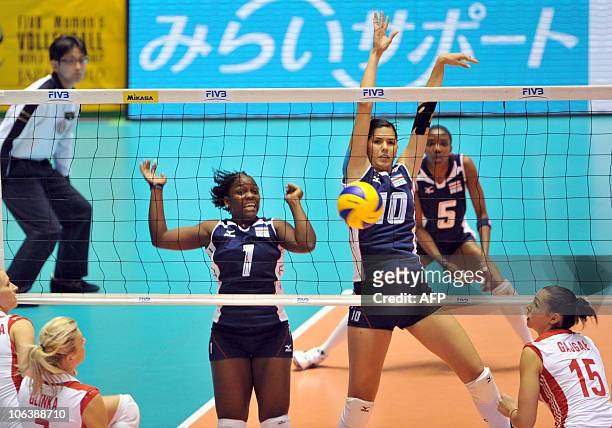 Costa Rica's Dionisia Thompson and Paola Ramirez Vargas block the ball against Poland during the first round of the world woman's volleyball...