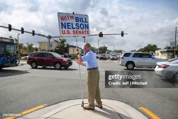 Senator Bill Nelson holds his original election sign at US 1 at US 1 & Eau Gallie Blvd during the final full day of campaigning in the midterm...