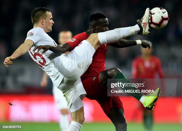 Poland's defender Tomasz Kedziora vies with Portugal's forward Bruma during the international UEFA Nations League football match between Portugal and...