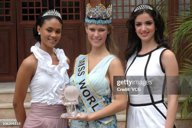 Emma Wareus of Botswana, Alexandria Mills of the United States and Adriana Vasini of Venezuela pose for photos during a press conference at the...