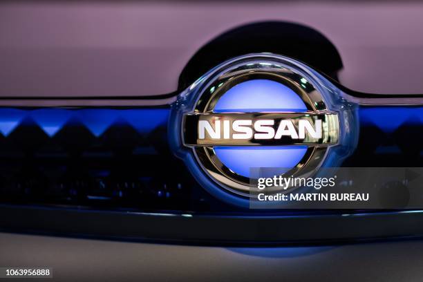 The Nissan logo is seen on a protoype in a Nissan showroom in Tokyo on November 21, 2018. - The crisis at Nissan deepened on November 21 as it...