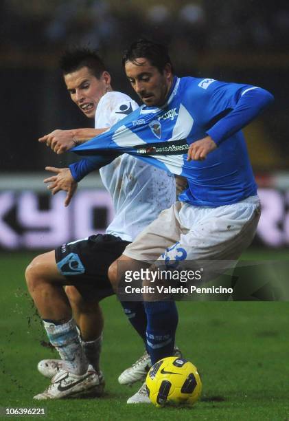 Simone Dallamano of Brescia Calcio is pulled by his shirt by Marek Hamsik of SSC Napoli during the Serie A match between Brescia Calcio and SSC...