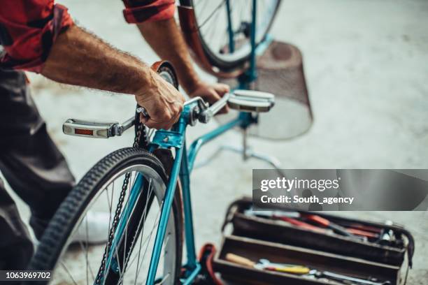 fixing bicycle - bicycle repair stock pictures, royalty-free photos & images