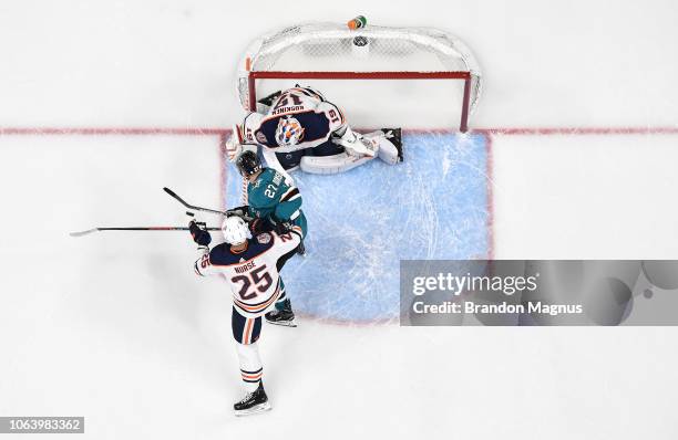 An overhead view of Joonas Donskoi of the San Jose Sharks crashing the net against Darnell Nurse and Mikko Koskinen of the Edmonton Oilers at SAP...