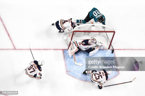 An overhead view of Marcus Sorensen of the San Jose Sharks taking a shot on net against Mikko Koskinen and Kris Russell of the Edmonton Oilers at SAP...