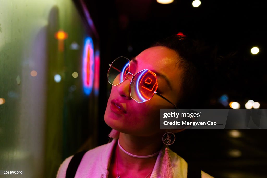 Portrait of young woman under neon light