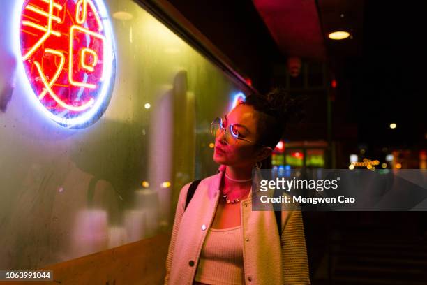 portrait of young woman under neon light