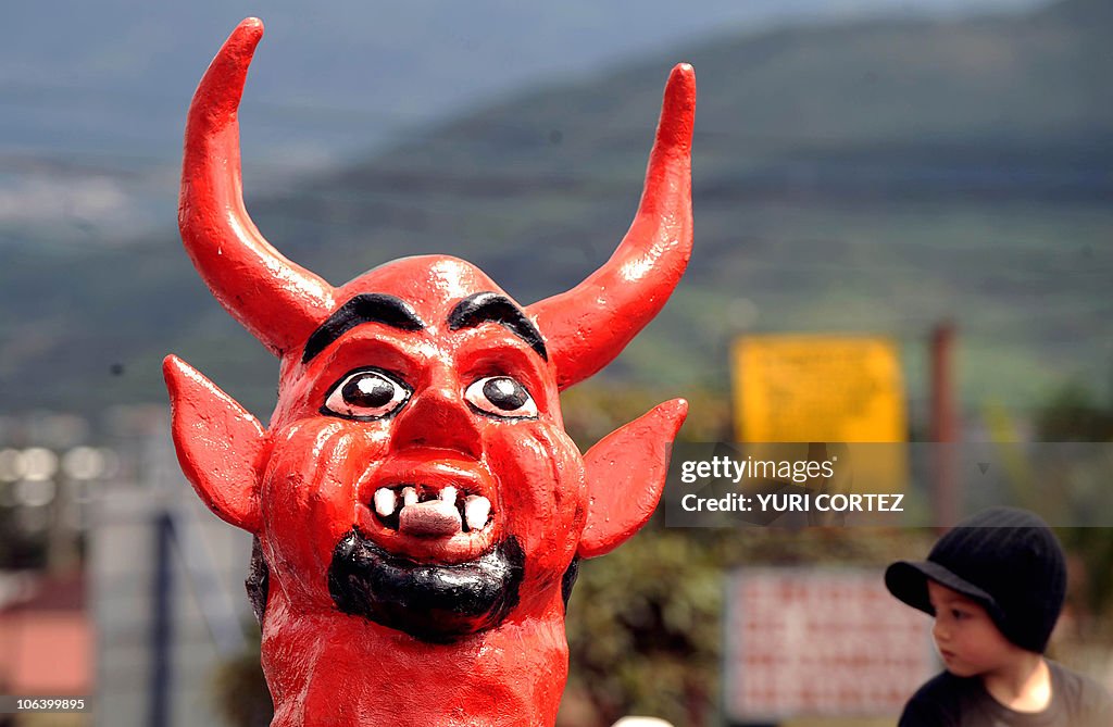 A person wearing a devil mask participat