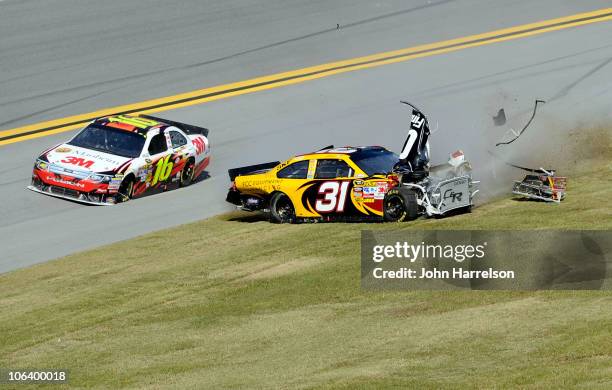 Jeff Burton, driver of the Cat Financial Chevrolet, spins out on the grass as Greg Biffle drives the 3M Ford during the NASCAR Sprint Cup Series AMP...